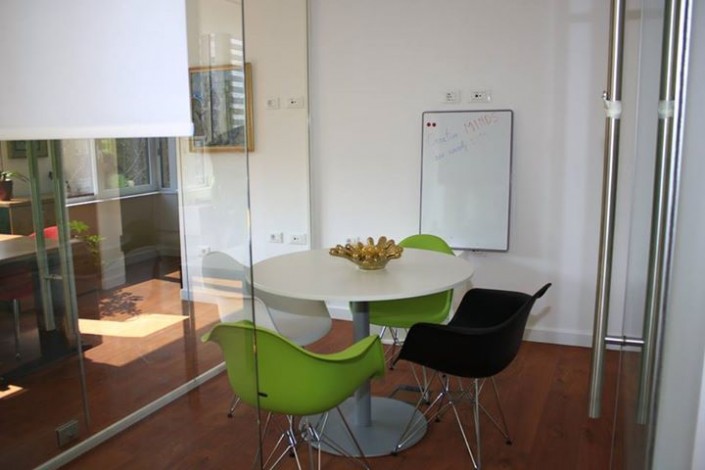 Small meeting room with round table and whiteboard